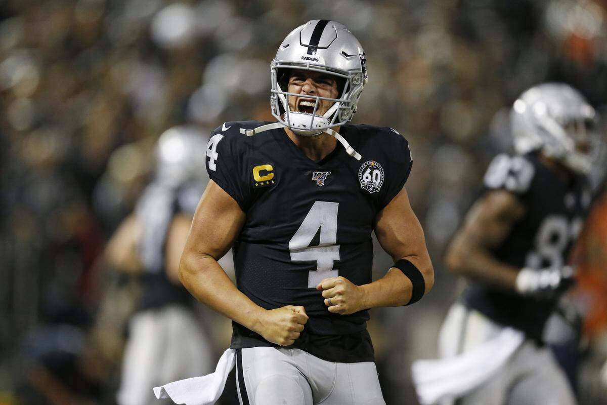 Oakland quarterback Derek Carr celebrates after a touchdown during the Raiders’ 26-14 win over the Denver Broncos on Monday.