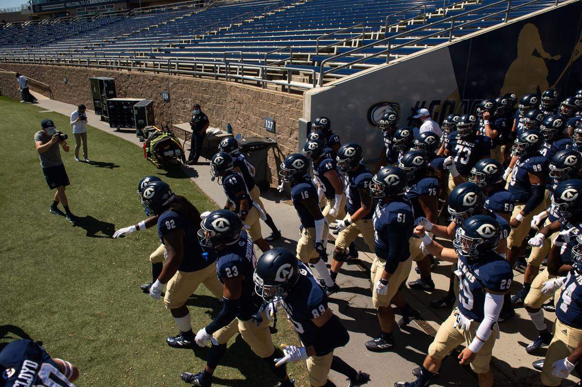 The UC Davis football team takes the field against Idaho State in March at UC Davis Health Stadium. Fielding a team with more than 100 male participants requires the school to provide provide woman’s teams with an equal number of athletic opportunities.