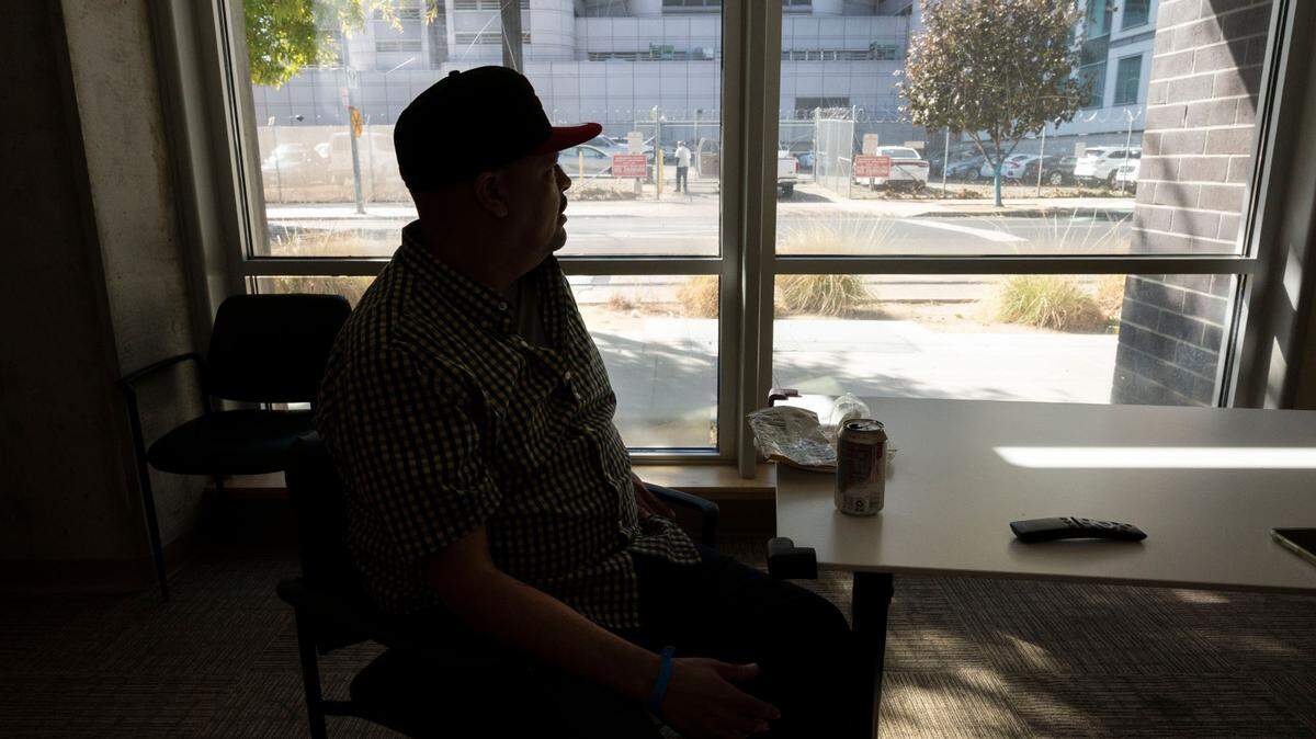A man named Anthony eats a snack and watches some television while resting at the Wellspace SURE Center on Thursday, Oct. 14, 2021.