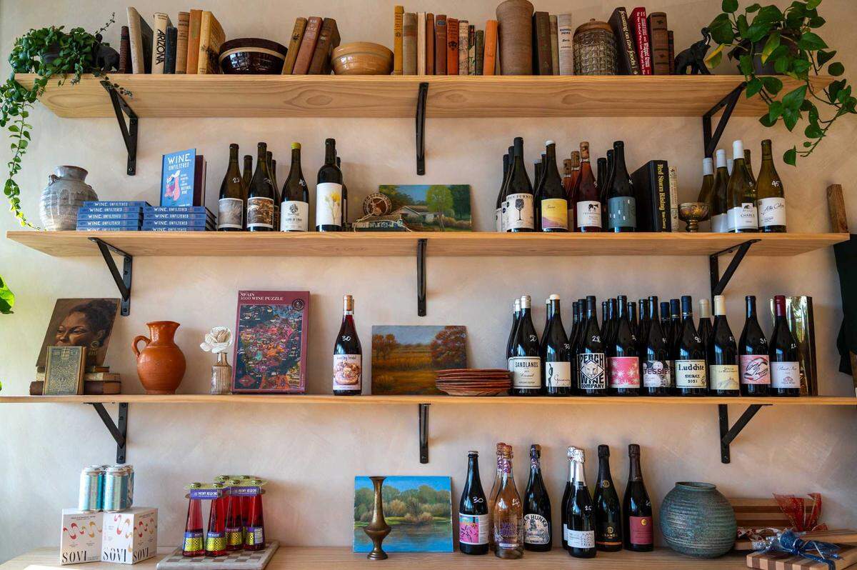 Books about wine, wine bottles and other merchandise are available at Ever After Wine in Elk Grove on Wednesday.