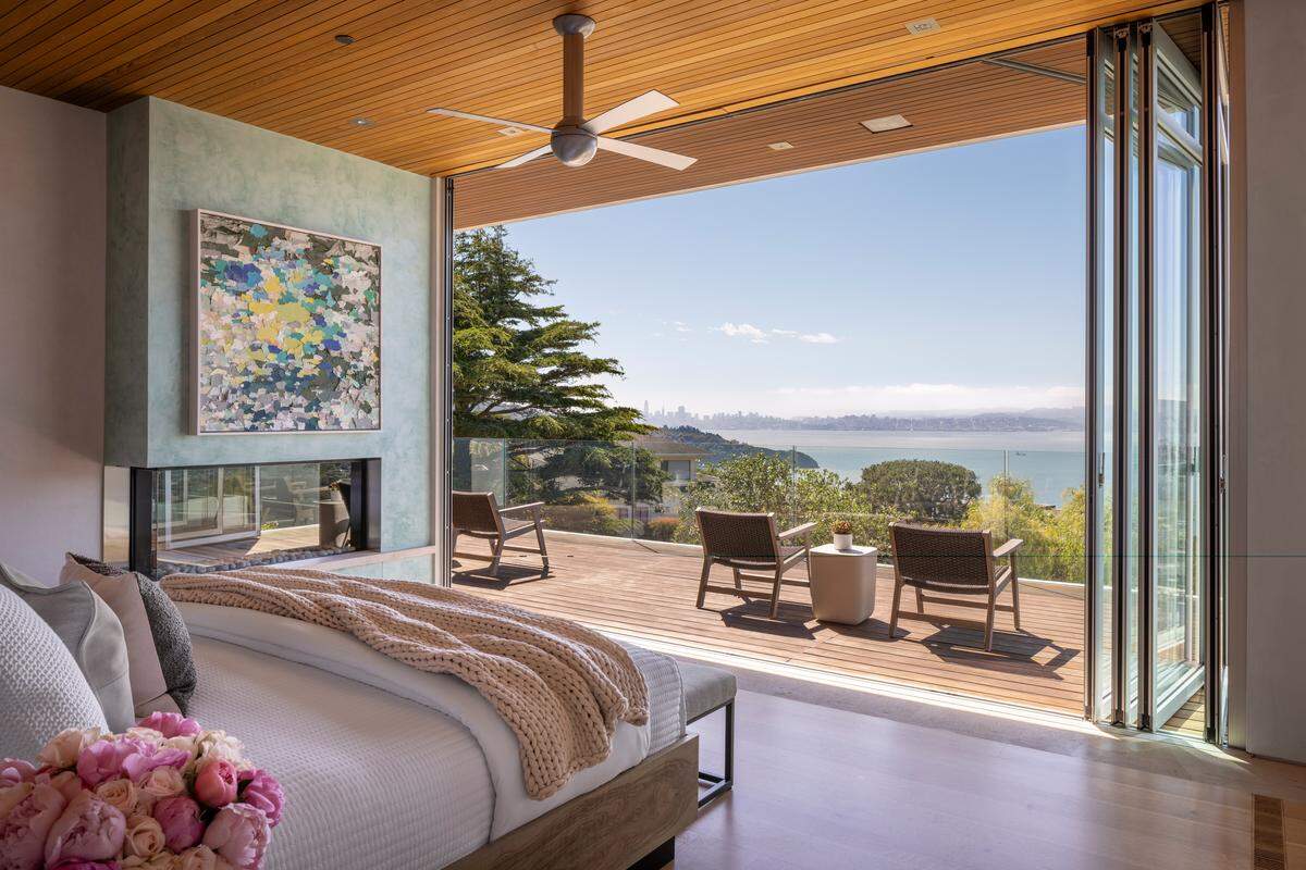 The primary bedroom, one of four bedrooms, brings in exclusive San Francisco Bay views.