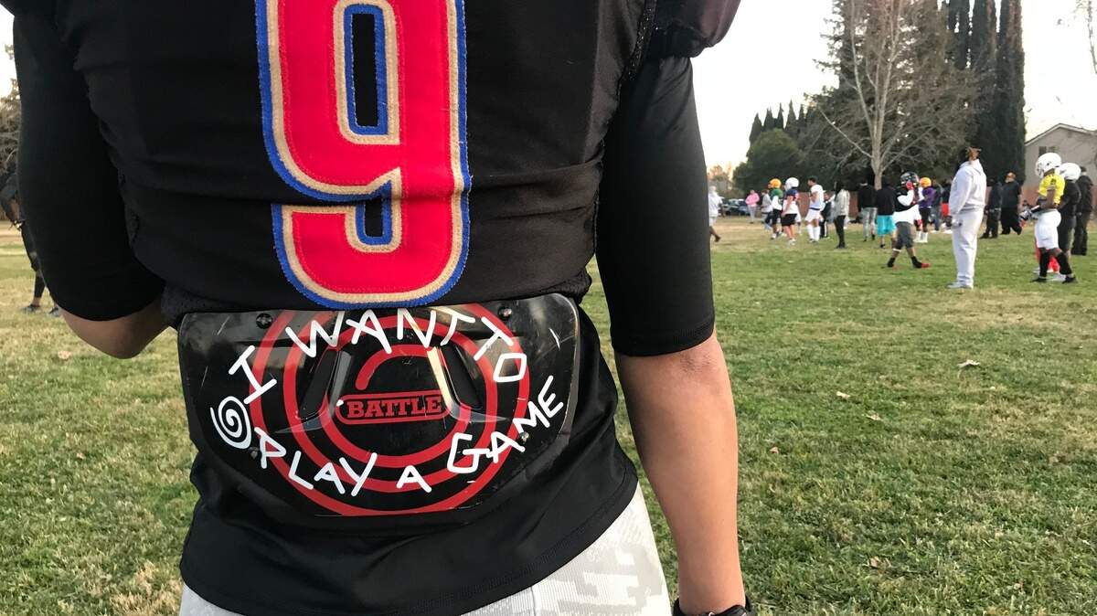 A player stands on the sidelines at a 2021 scrimmage for the Sacramento Irons, a club football team.