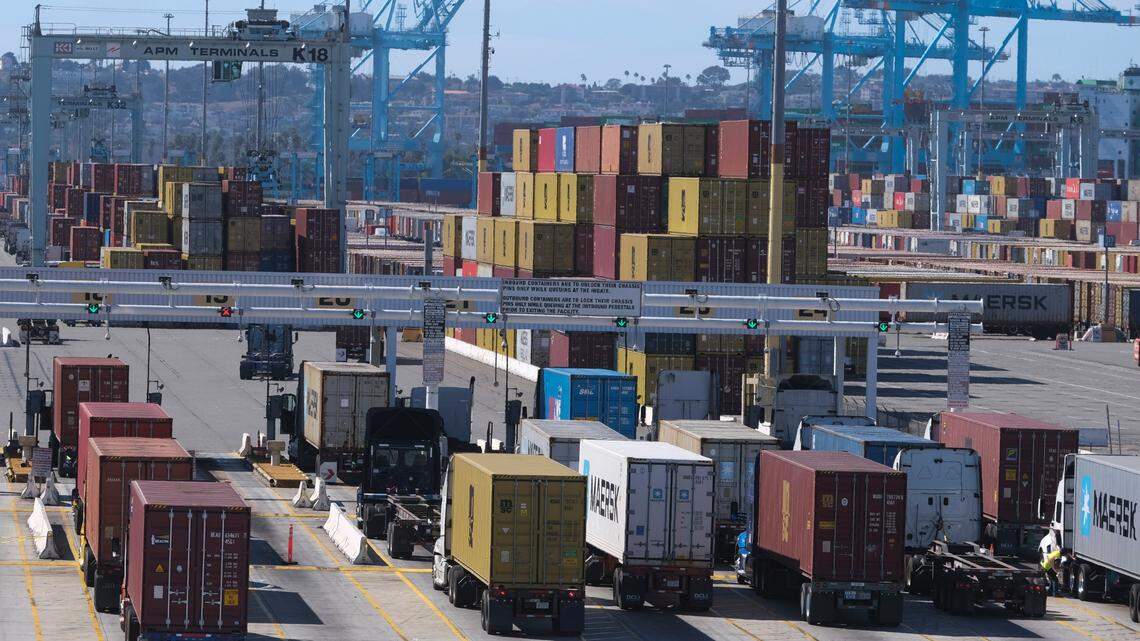 Cargo container trucks wait in line to enter AMP Terminals at the Port of Los Angeles, Oct. 20, 2021 in San Pedro, Calif. (AP Photo/Ringo H.W. Chiu)
