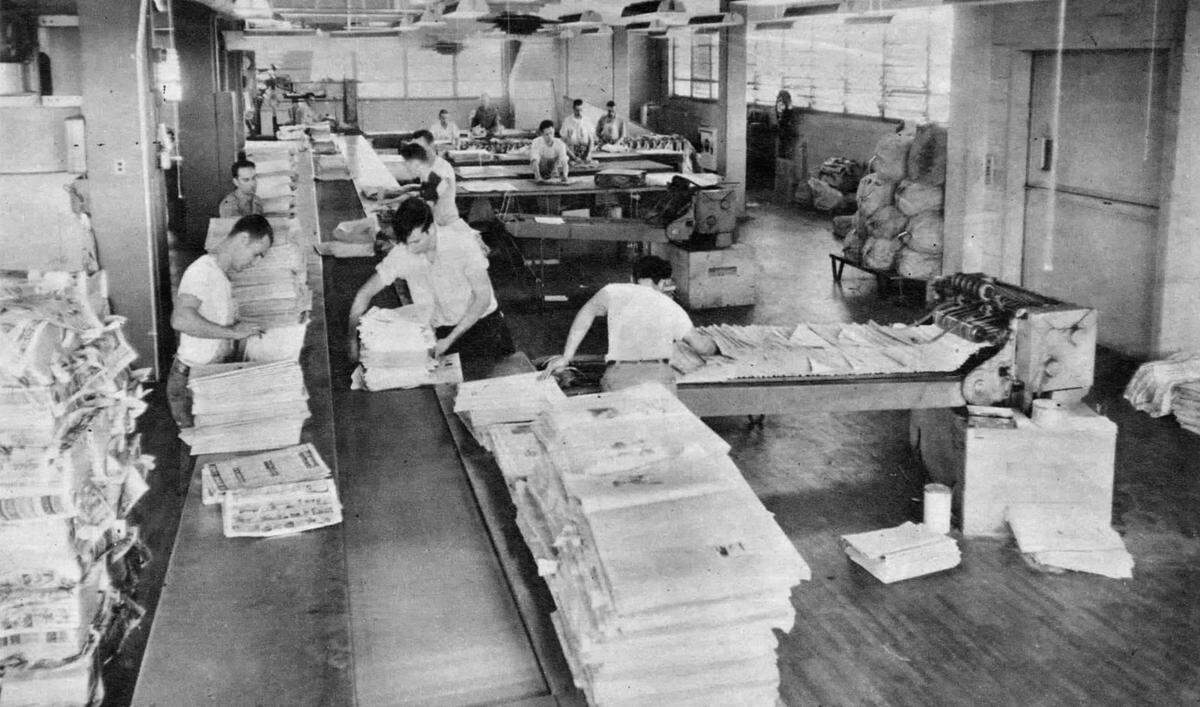 Mailroom workers sort newspapers before delivery at The Sacramento Bee’s new building at 21st and Q streets in 1952. They came to the mailroom in lots of 25 or 50 “counted magically by the press.”
