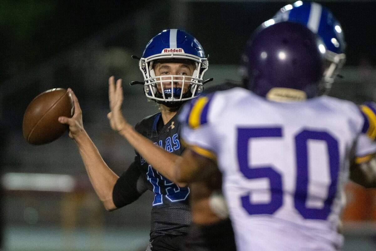 El Dorado quarterback Anthony Mahaffey looks down field to pass against Bret Harte’s Massen Pruden during a game El Dorado High School in Placerville, Monday, Sept. 12, 2022.