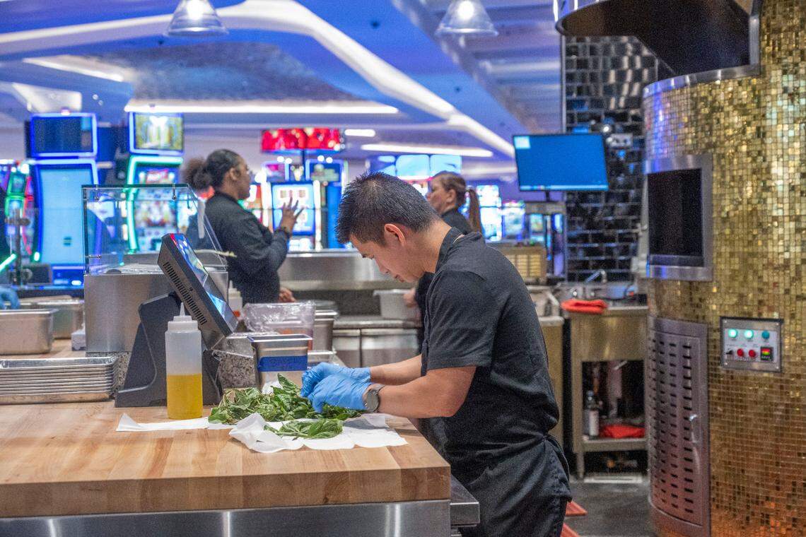 Am Nguyen, a line cook at Chickie’s Pizzeria, preps vegetables at The Market at Sky River Casino on Aug. 15. The casino has 17 restaurants.