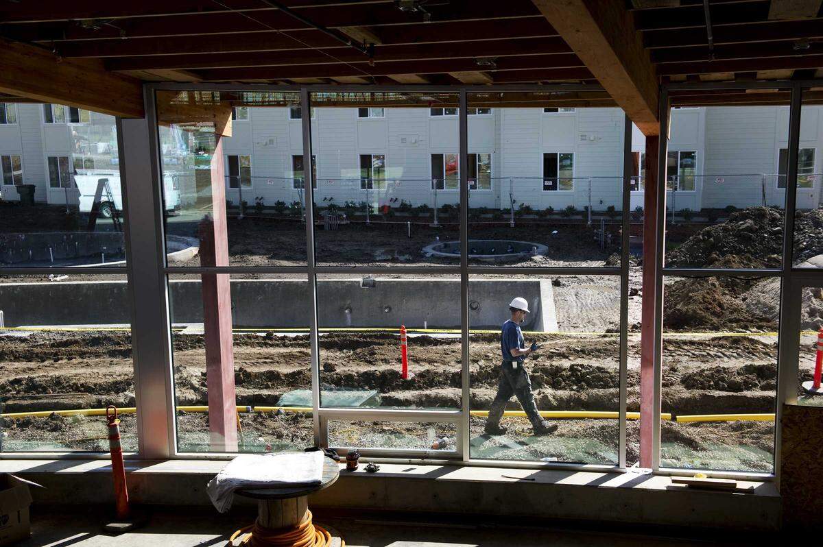 A construction worker walks past the unfinished pool at The Center at The Ramble, part of the West Village student housing complex at UC Davis in 2011. While UC Davis has added thousands of students and expanded housing like West Village, the city itself hasn't kept pace with family housing, contributing to a sharp drop in school enrollment.