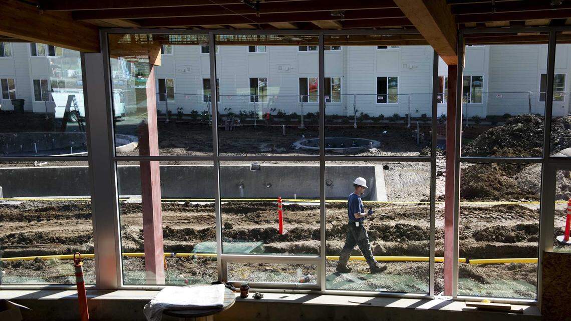 A construction worker walks past the unfinished pool at The Center at The Ramble, part of the West Village student housing complex at UC Davis in 2011. The university’s continued growth has fueled demand for housing as city leaders and residents debate the proposed Village Farms development and how to balance expansion with Davis’ tradition of slow growth.
