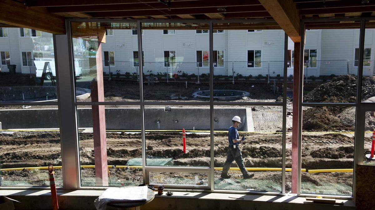 A construction worker walks past the unfinished pool at The Center at The Ramble, part of the West Village student housing complex at UC Davis in 2011. The university’s continued growth has fueled demand for housing as city leaders and residents debate the proposed Village Farms development and how to balance expansion with Davis’ tradition of slow growth.