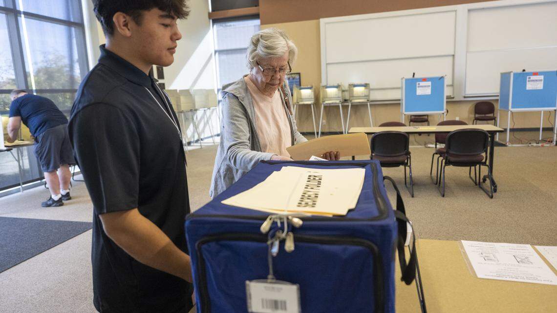 Irene Webb, of Folsom, inserts her ballot into the ballot "box" after voting on Proposition 50 at Folsom Lake College on Tuesday, Nov. 4, 2025, as a student election clerk observes.