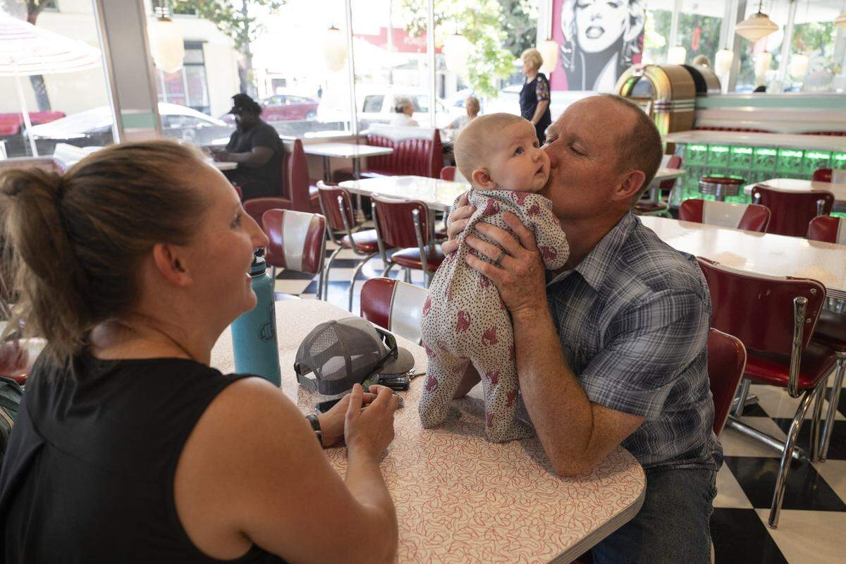 Bryan Johnson, right, Lisa Johnson, left, and their daughter Ruth dine for the first time at Rick’s Dessert Diner in midtown Sacramento on Tuesday.