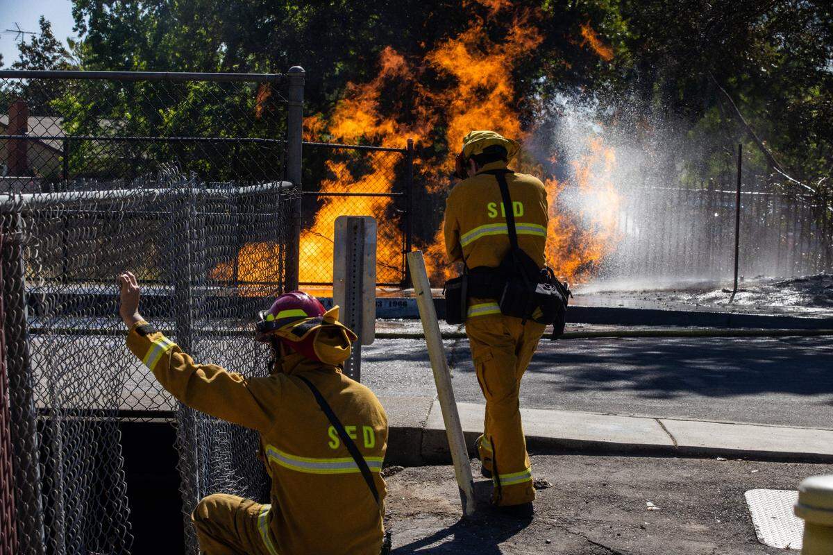 Sacramento firefighters respond to a gas fire that ignited in an underpass after a line was ruptured on Tangerine Avenue in May.