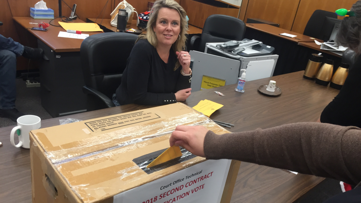 Brooke Ryan, Sacramento Superior court employee and union representative, greets a court worker who casts her ballot during a vote on a new labor contract at Sacramento County Courthouse, Friday, Dec. 21.