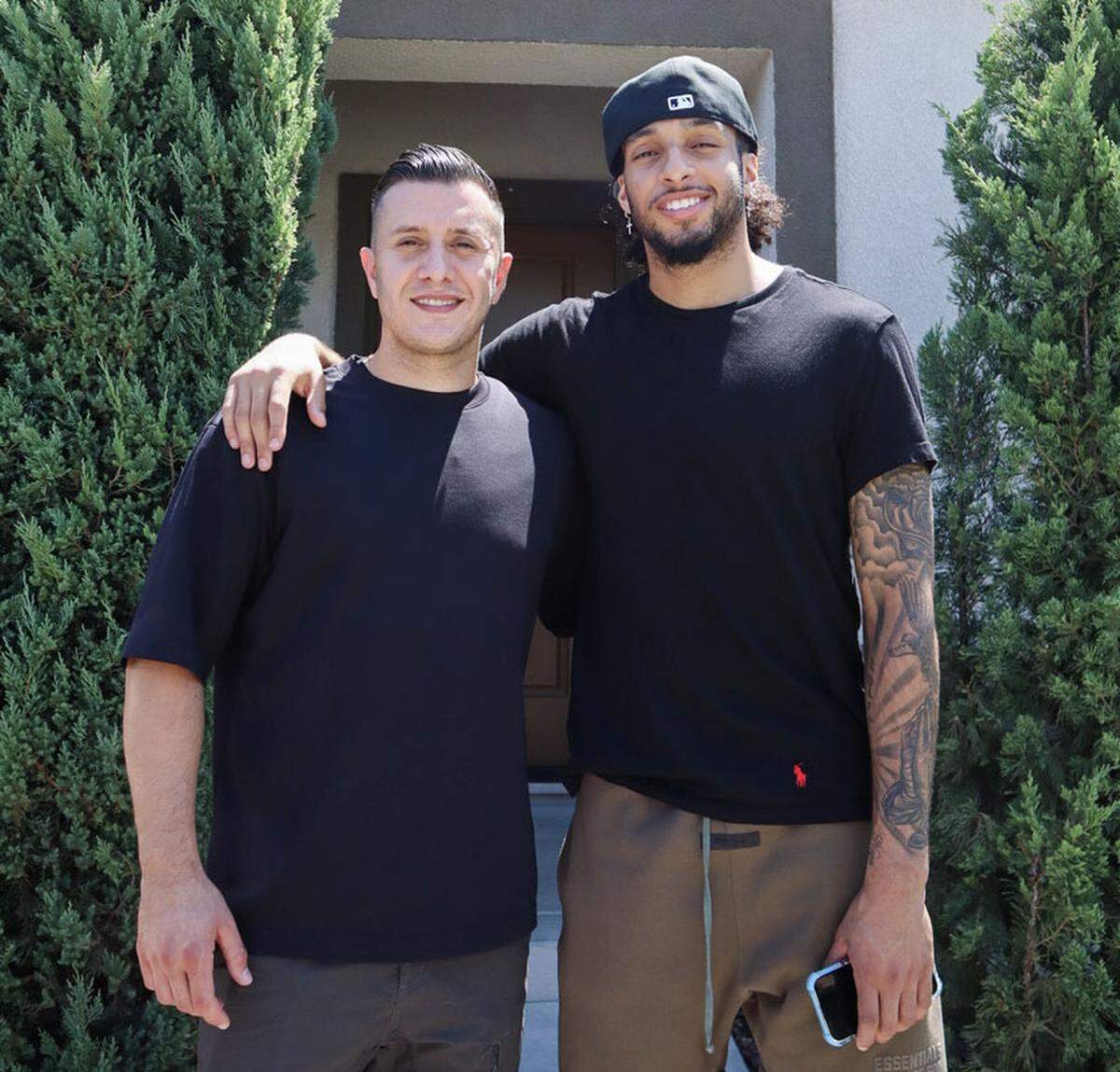 Real estate agent Matthew Hindy stands with Sacramento Kings player Devin Carter outside his new home in an image shared on Instagram in 2024.