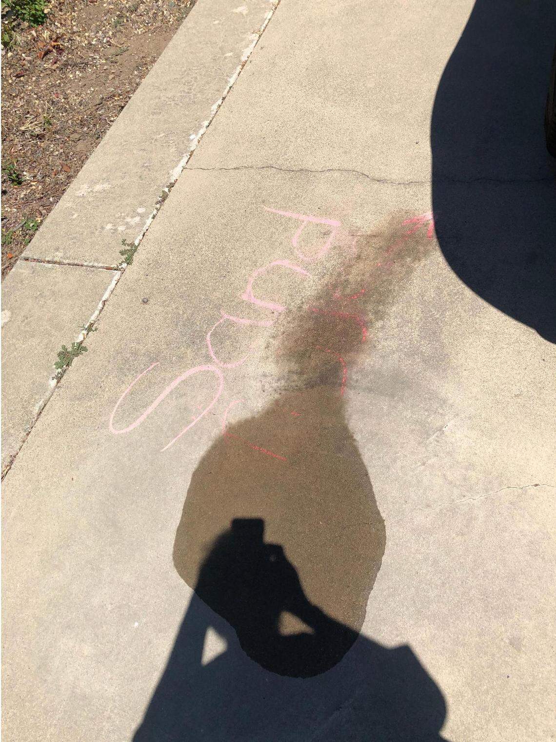 A racial slur written on the driveway of Rouble Claire’s home in Sutter, California, on May 11, 2021. Claire says a Sutter County sheriff’s deputy partially washed away the slur with his water bottle without taking any photos of the chalk as evidence.