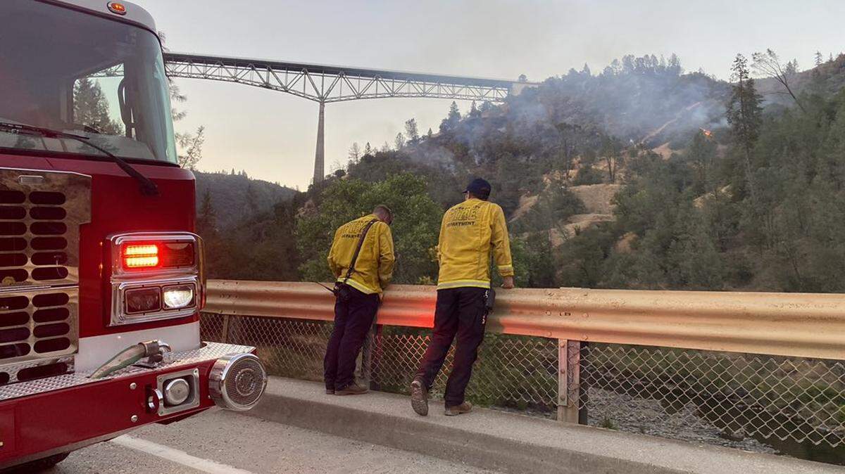 Firefighters monitor the Bridge Fire burning under the Foresthill Bridge on Sunday, Sept. 5.