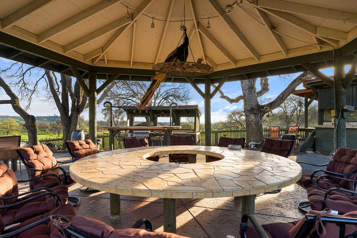 At the tabletop pavilion, property owner Brian Kraft said friends once stayed up under kerosene lanterns around the round stone table, using the outdoor setup for barbecues before the property had power.