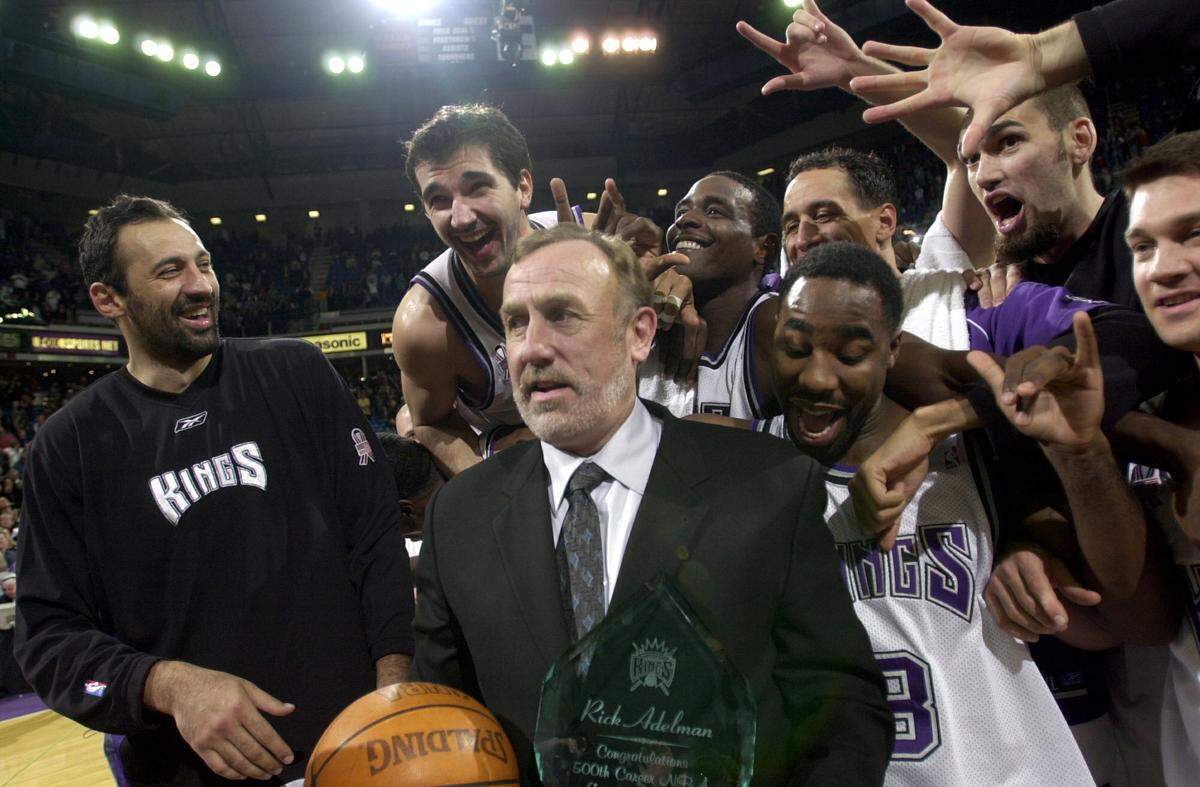 Sacramento Kings coach Rick Adelman is mobbed by his players – including Vlade Divac, Peja Stojakovic, Chris Webber, Doug Christie and Jabari Smith – after the coach’s 500 career victory, against the Orlando Magic at Arco Arena on Tuesday, Dec. 11, 2001.