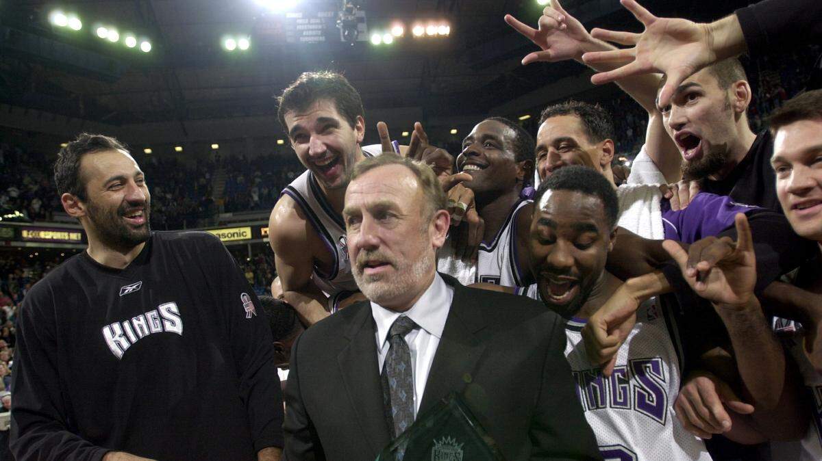 Sacramento Kings coach Rick Adelman is mobbed by his players – including Vlade Divac, Peja Stojakovic, Chris Webber, Doug Christie and Jabari Smith – after the coach’s 500 career victory, against the Orlando Magic at Arco Arena on Dec. 11, 2001.