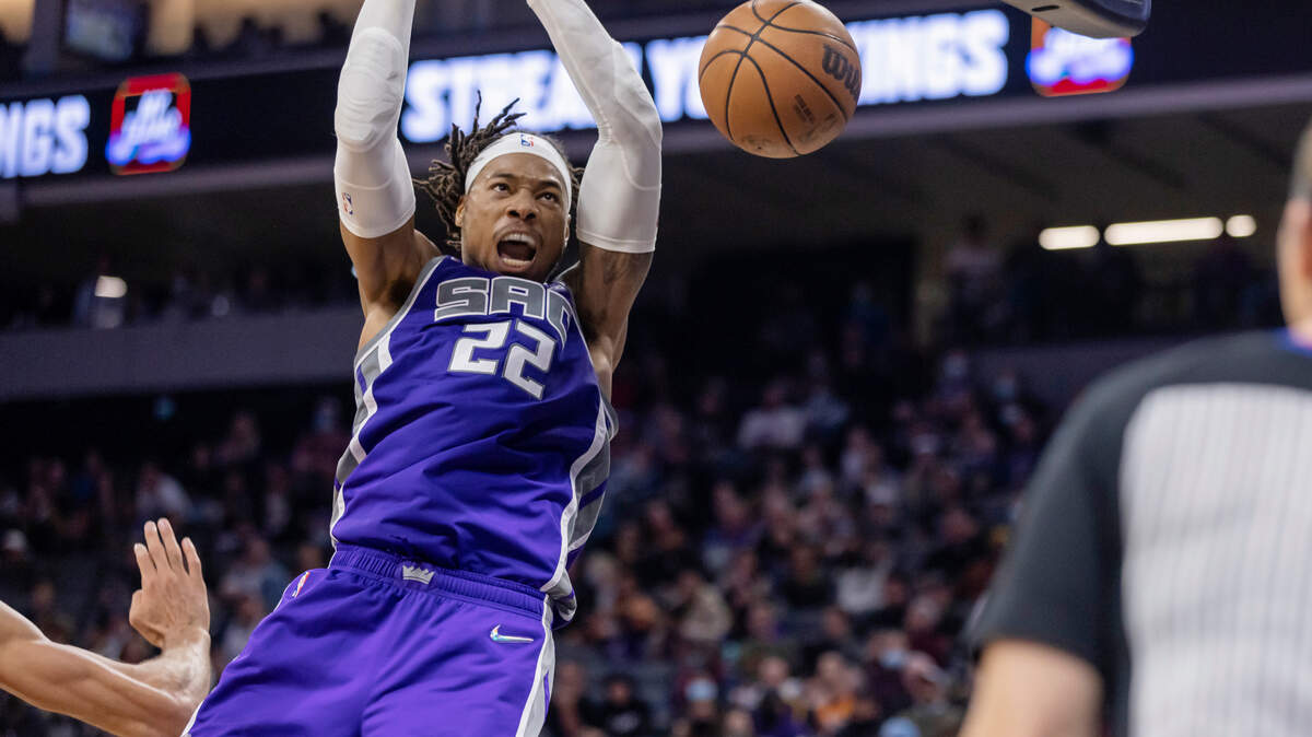 Sacramento Kings center Richaun Holmes (22) makes an alley-oop dunk with the assist from Kings guard Tyrese Haliburton (0) during the third quarter on Saturday, Nov. 20, 2021 during an NBA basketball game at the Golden 1 Center in Sacramento. Holmes was the top scorer with 22 points. The Jazz won 123-105.