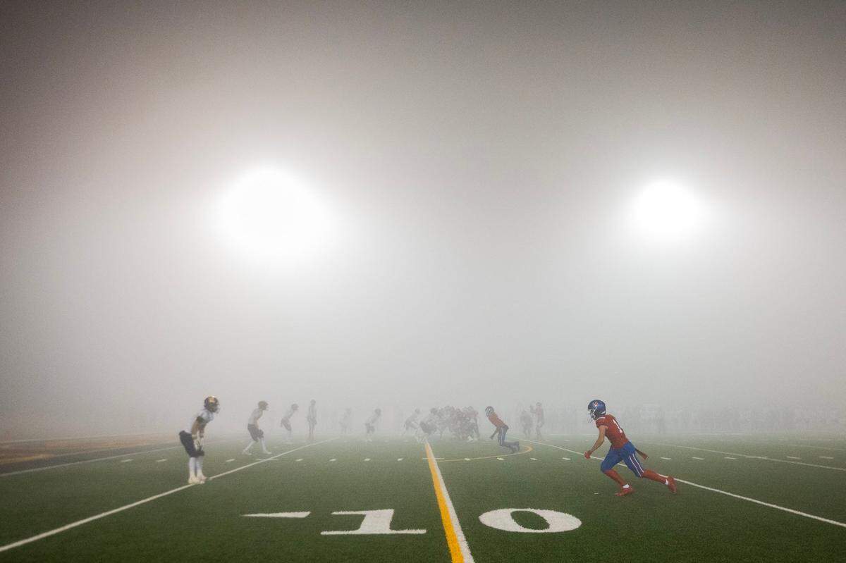 The Folsom Bulldogs and the Oak Ridge Trojans played much of the second half in fog in th CIF Sac-Joaquin Section Division l championship game on Saturday at Hughes Stadium in Sacramento.