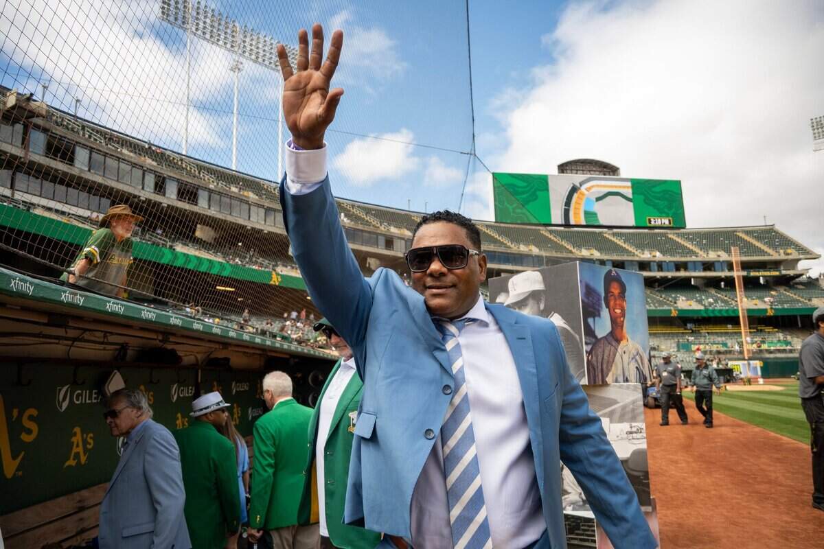 Miguel Tejada waves to fans in the stands before the former shortstop was honored with his induction into the Oakland Athletics Hall of Fame on Aug. 17 at the Oakland Coliseum.