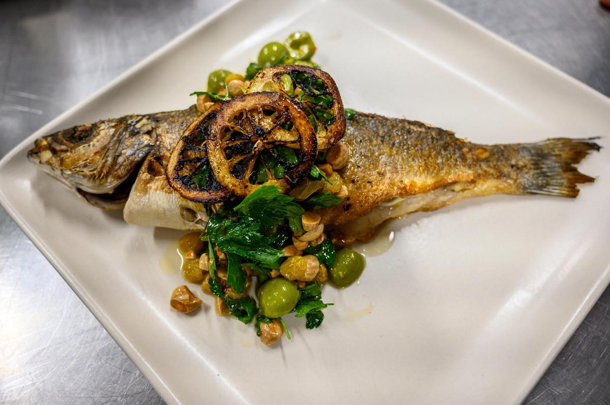 Whole grilled Branzino served with pickled golden raisins, olives and macron almonds, is a shared dish ready to be served at Shangri-La on Tuesday Oct.15, 2019.