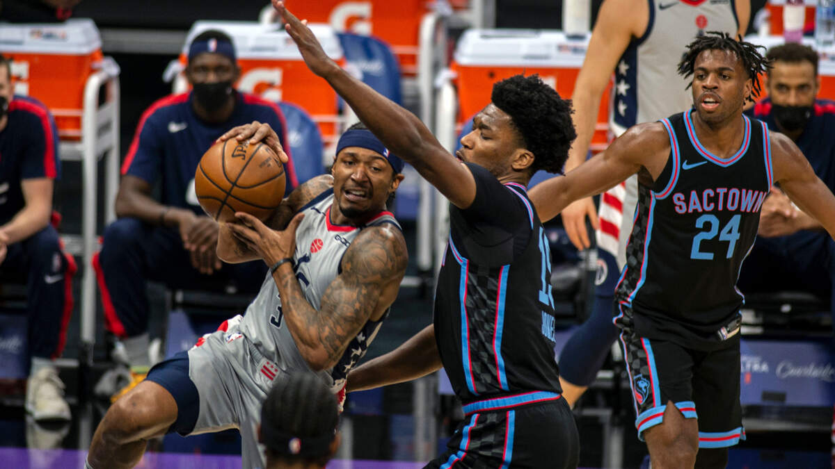 Washington Wizards guard Bradley Beal (3) drives to the basket as he’s defended by Sacramento Kings center Damian Jones (15) during the first quarter of an NBA basketball game in Sacramento, Calif., Wednesday, April 14, 2021. (AP Photo/Hector Amezcua)