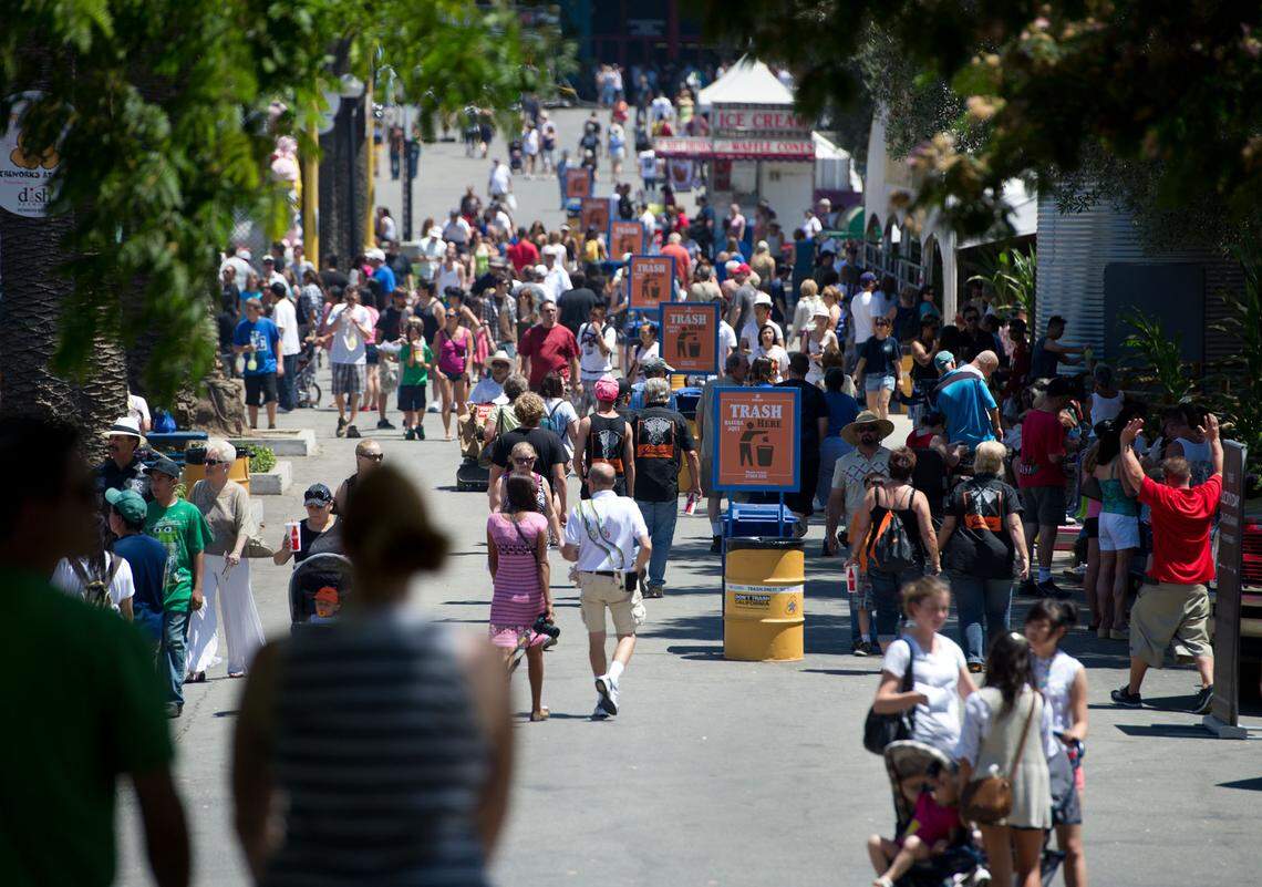Fairgoers walk the grounds at Cal Expo in 2011. As the fair prepares to open for the first time during the pandemic, fair officials say they are prepared to have a safe festival this year.