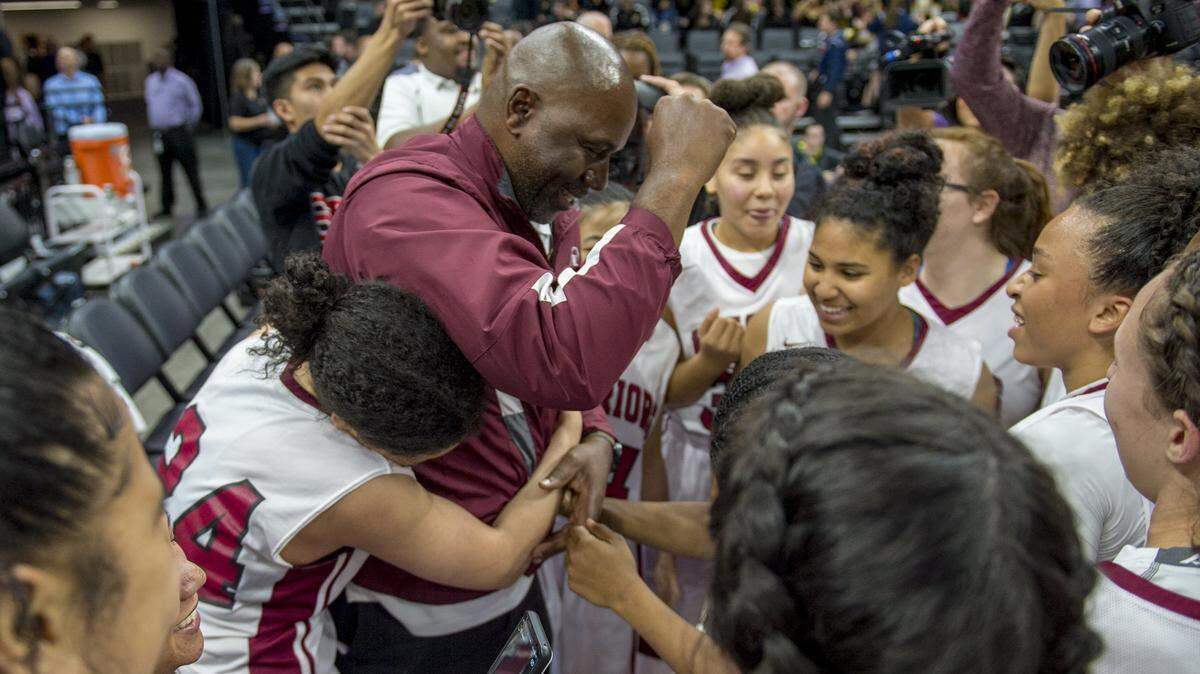 West Campus coach John Langston celebrates with his team after the Warriors won their second consecutive state championship, defeating Sunny Hills in the CIF State Division III basketball final on Friday, March 23, 2018 at Golden 1 Center.