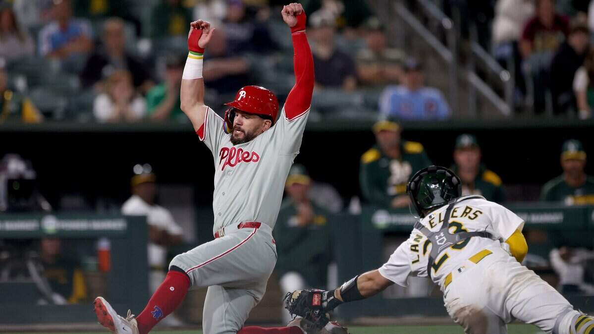 May 24, 2025; West Sacramento, California, USA; Philadelphia Phillies designated hitter Kyle Schwarber (12) scores on a sacrifice fly by Nick Castellanos (not pictured) against the Athletics during the eleventh inning at Sutter Health Park. Mandatory Credit: Dennis Lee-Imagn Images