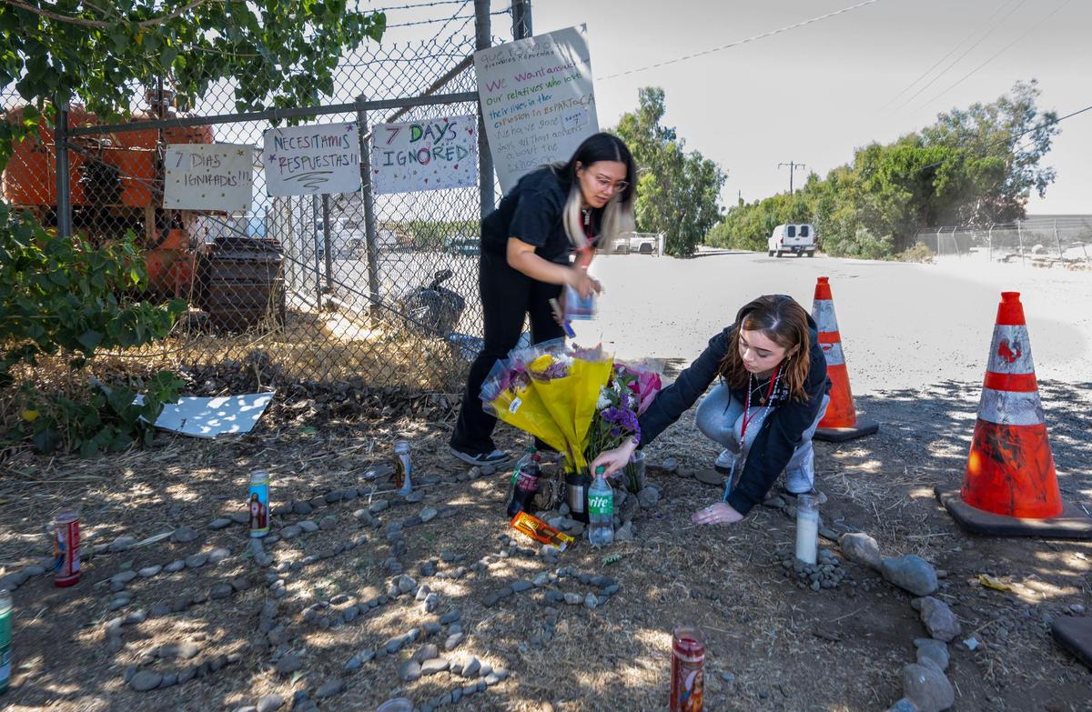 Charlize Hernandez, left, who lost three cousins in the Esparto fireworks warehouse explosion, and Syanna Ruiz, who lost her boyfriend Jesus Ramos, place food and drinks that the young men liked at a memorial after family members gathered on Monday, July 7, 2025. Hernandez questioned a statement made at a news conference that family members have been kept updated about the investigation. “Every time we hear something, we hear it from the media,” she said.