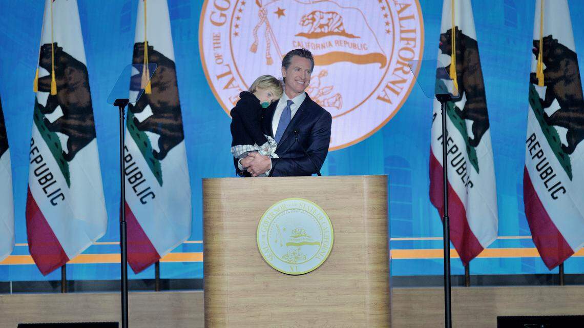 Governor Gavin Newsom holds his son Dutch, 2, during his inauguration address on Monday, Jan. 7, 2019.