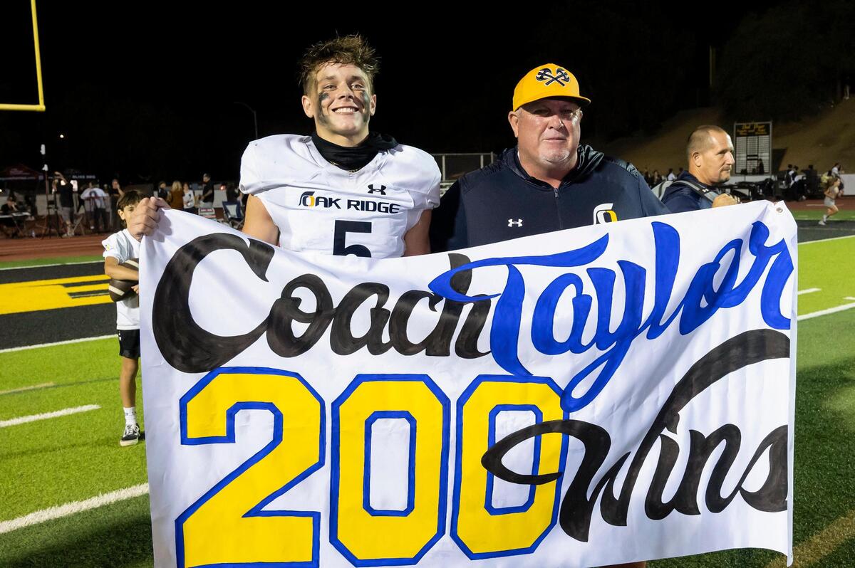 Oak Ridge coach Casey Taylor poses for a photo with his son Jackson Taylor (5) after a 2013 win against the Del Oro Golden Eagles. It was the coach’s 200th career win, and it came against Del Oro, where he won 148 of those games.