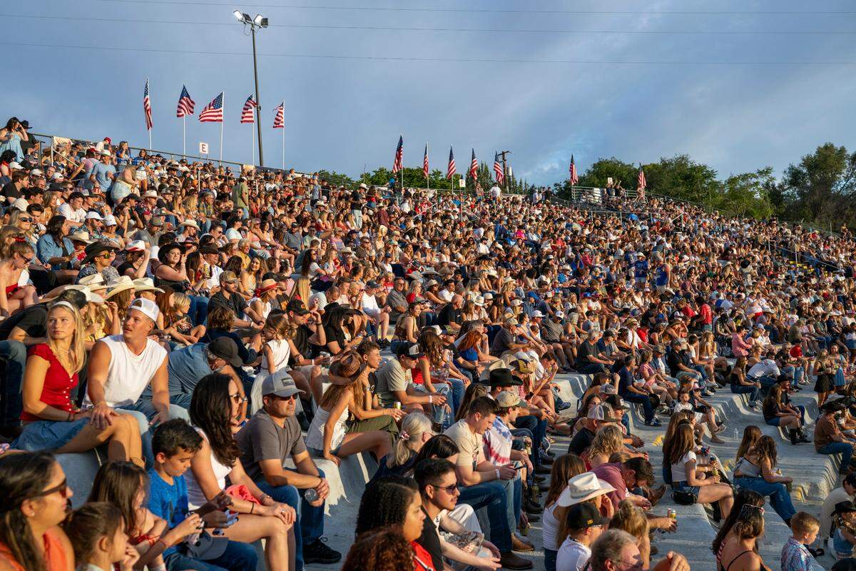 Spectators sit in the stands as the sun sets on the sold-out Folsom Pro Rodeo on Thursday.