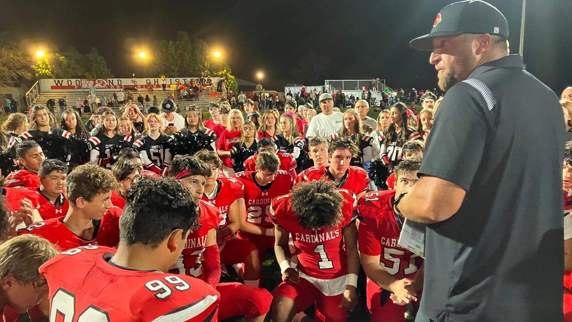 Woodland Christian coach Mike Paschke talks to his players after thumping Delta on Friday, Oct. 7, 2022.