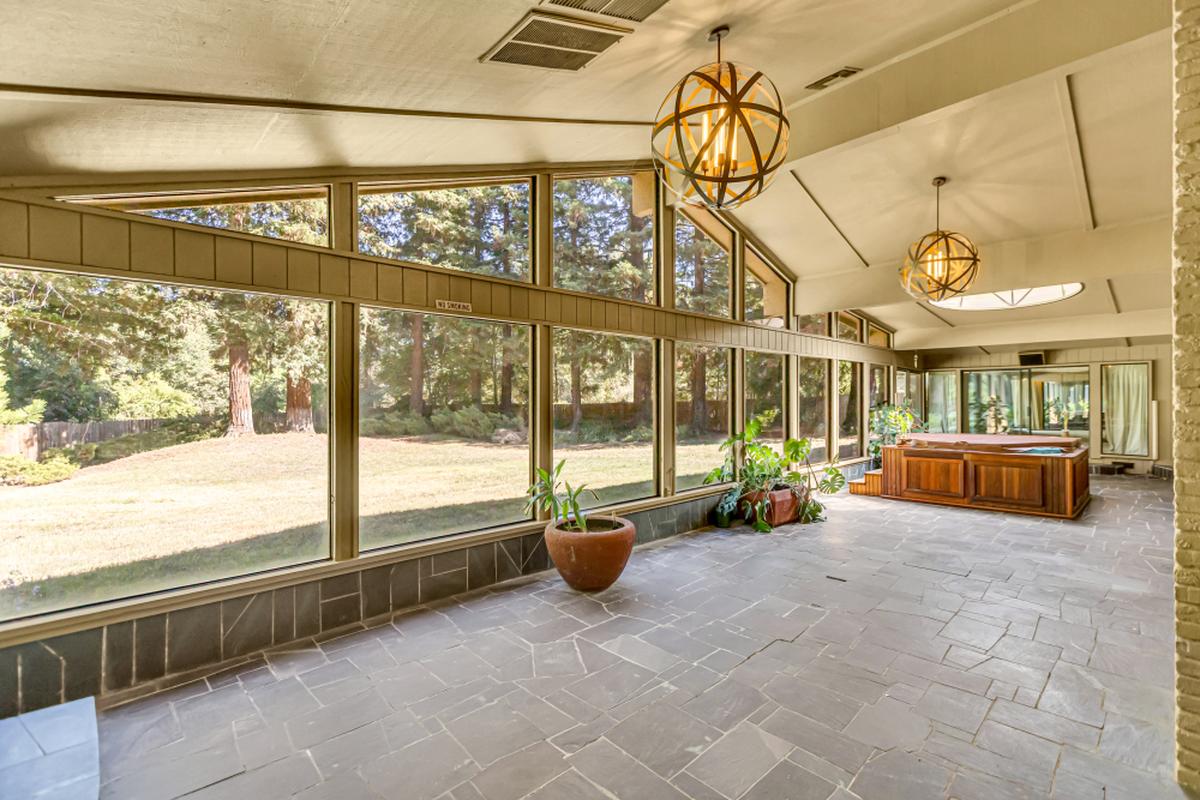 Clerestory windows and a dramatic dome skylight transform the Hazel Avenue home’s sunroom into a light-filled sanctuary that connects indoor and outdoor spaces.