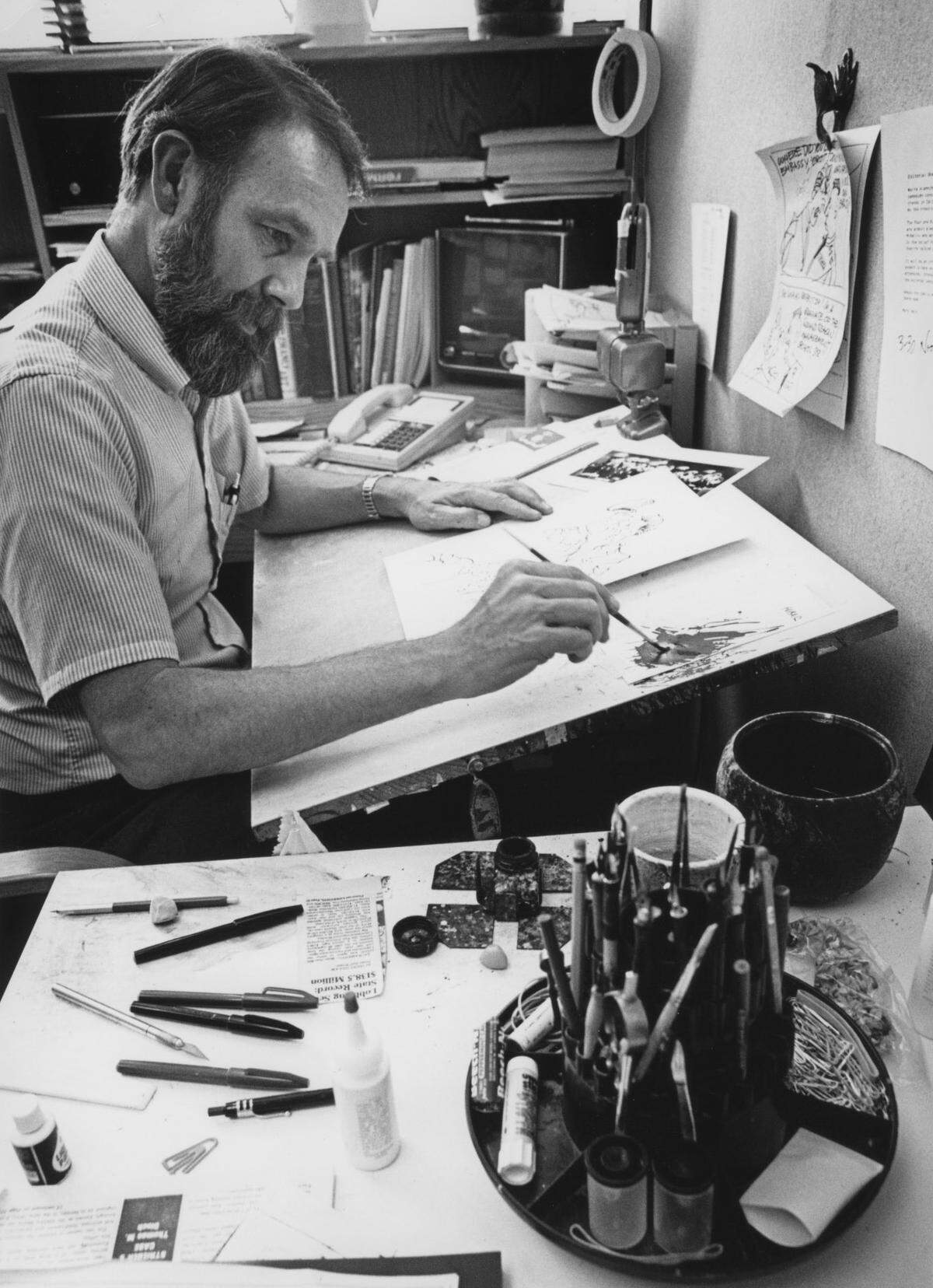Sacramento Bee editorial cartoonist Dennis Renault applies tint to a cartoon in his Bee office in 1978.