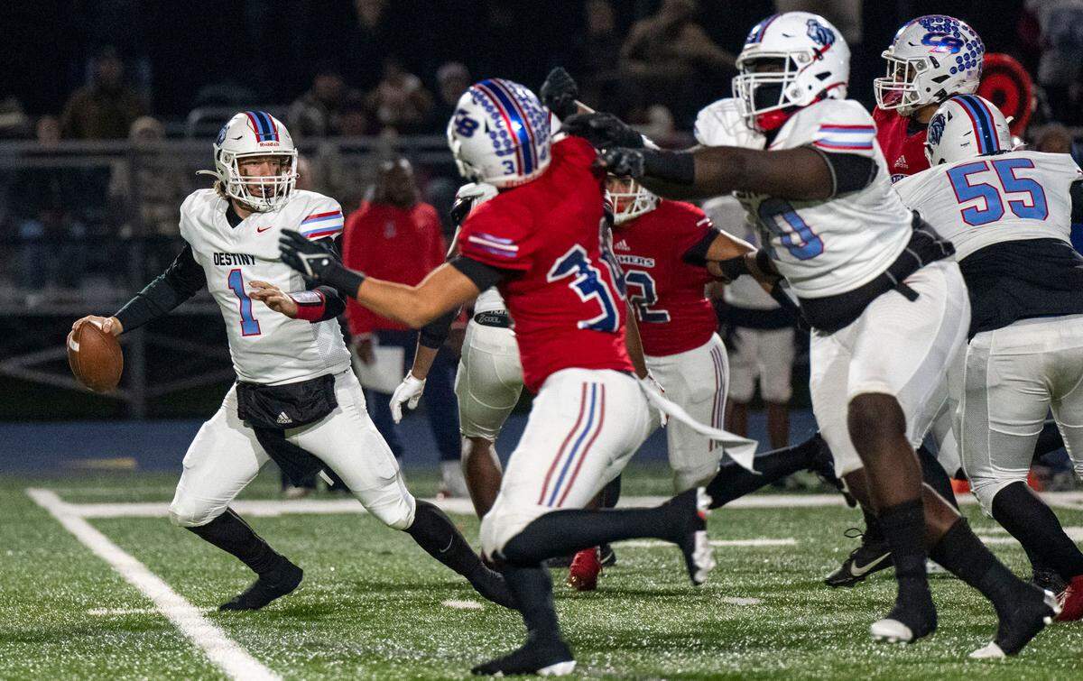 Destiny Christian Lions quarterback Dallas Munn (1) scrambles under pressure from Christian Brothers Falcons’ Jaxson Aurich (34) in a Sac-Joaquin Section Division III quarterfinal game on Friday, Nov. 15, 2024, in Sacramento.