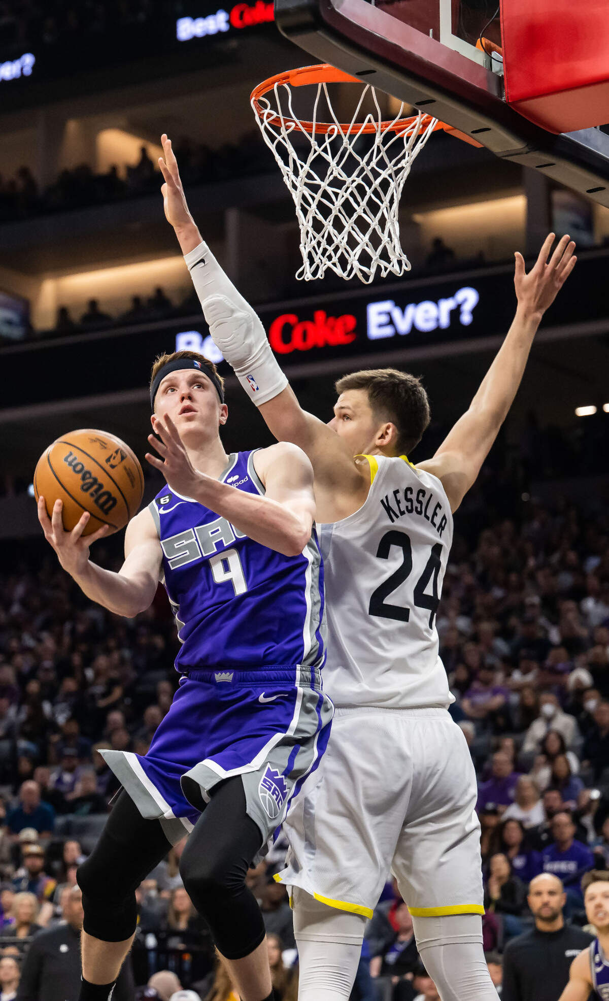 Sacramento Kings guard/forward Kevin Huerter (9) scores past Utah Jazz center Walker Kessler (24) during the fourth quarter at the NBA basketball game Saturday, March 25, 2023, at Golden 1 Center. The Kings beat the Jazz, 121-113.