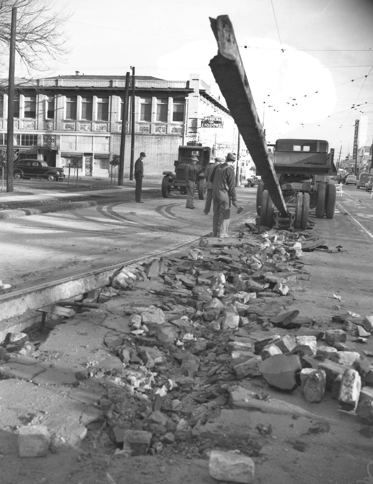 Workers remove the first section of Sacramento's streetcar rails in 1947 at the 35th Street entrance to James McClatchy Park in the city's Oak Park neighborhood. The rails were made useless when the streetcars were abandoned in favor of buses.
