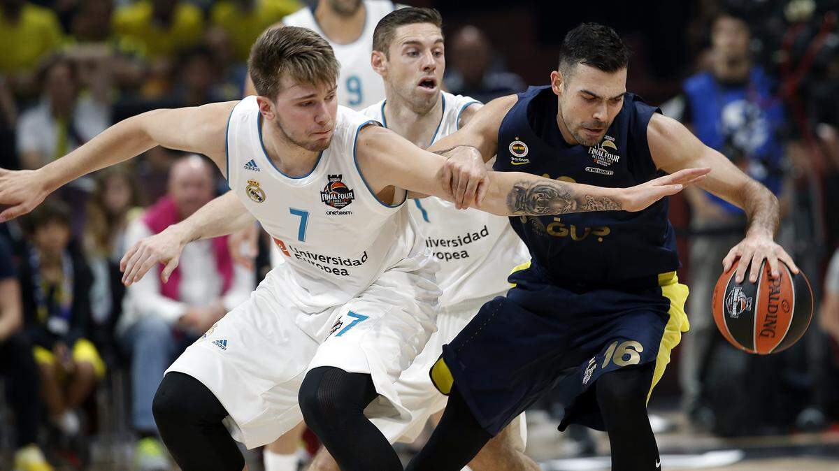 Real Madrid's Luka Doncic (7) tries to steal the ball from Kostas Sloukas of Fenerbahce Dogus Istanbul during Sunday's EuroLeague Final Four championship game Sunday in Belgrade, Serbia. Real Madrid won the title, and Doncic was named tournament MVP.