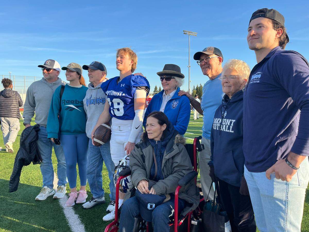 North quarterback Beau Ogles of Oakmont celebrates with family after helping his team defeat the South 35-7 in the 65h Optimist All-Star Football Classic on Saturday at Granite Bay High School.