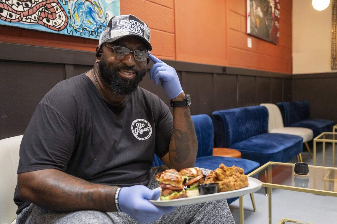 Elevated Eats owner Carlton Brown poses with his oyster mushroom slider sampler at TAP Wine Lounge in Sacramento on Dec. 4. Brown started the all-vegan business in 2025 and is currently serving out of TAP Wine Lounge’s kitchen.