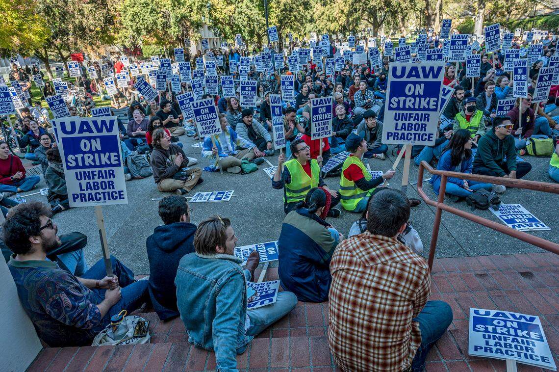 UC Davis academic researcher Andy Salazar, center with vest, participates in a strike on campus on Monday, Nov. 14, 2022. Academic workers across the University of California system walked off the job after contract negotiations broke down.