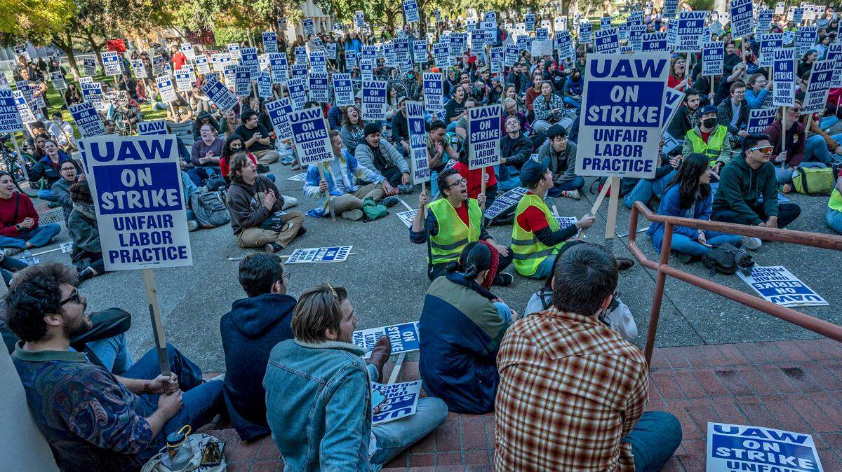 UC Davis academic researcher Andy Salazar, center with vest, participates in a strike on campus on Monday, Nov. 14, 2022. Academic workers across the University of California system walked off the job after contract negotiations broke down.