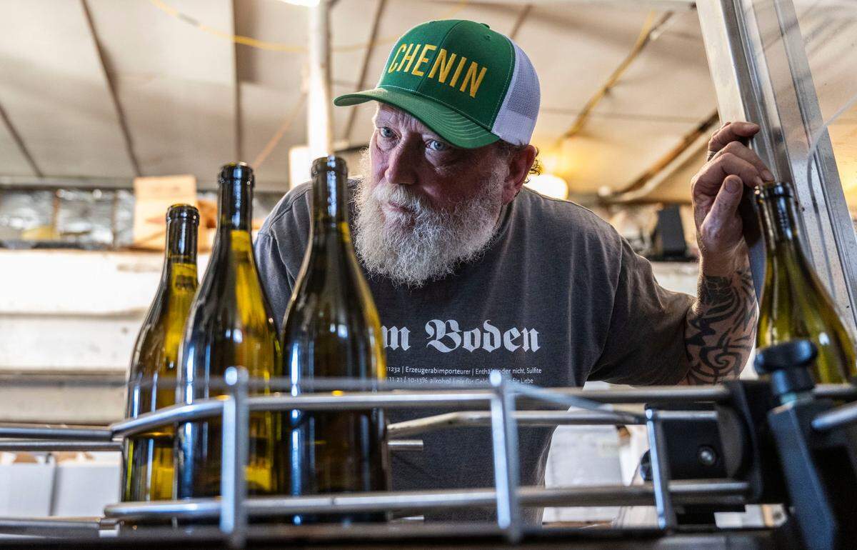 Craig Haarmeyer, owner of Haarmeyer Wine Cellars, keeps an eye on a bottling line on last month in West Sacramento.