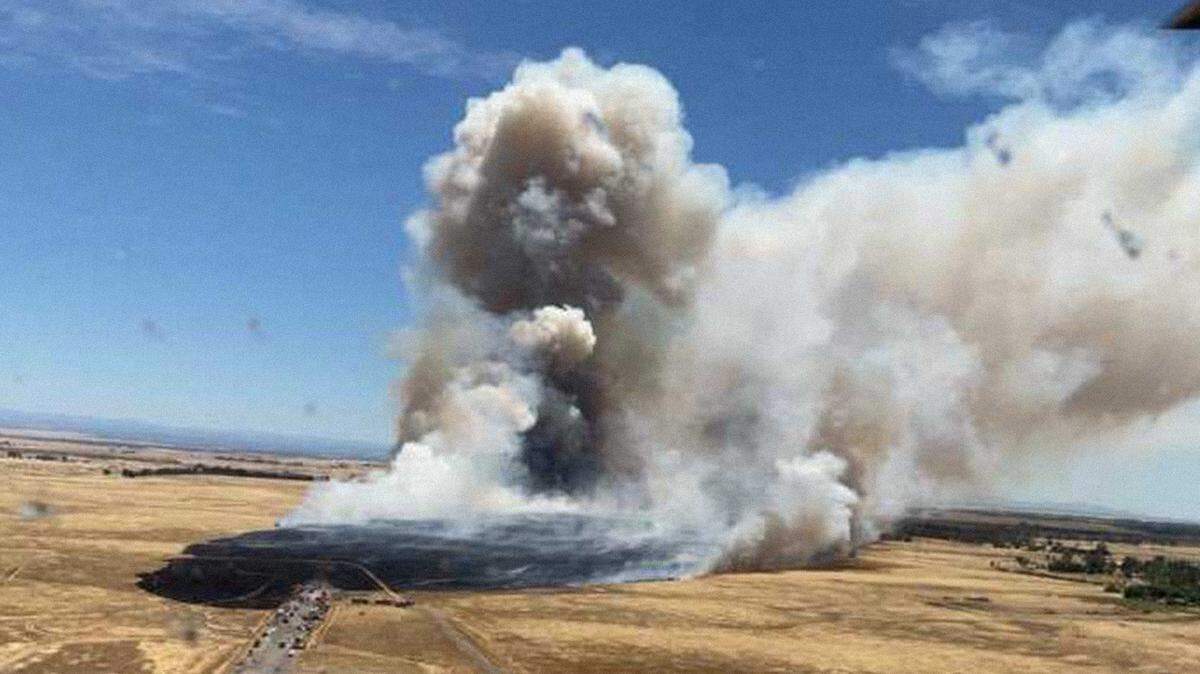 Smoke is seen billowing from the Excelsior Fire, a grass fire that sparked along Excelsior and Jackson roads, on Sunday, June 16, 2024. The fast-moving blaze burned at least 800 acres and several outbuildings in southeastern Sacramento County.