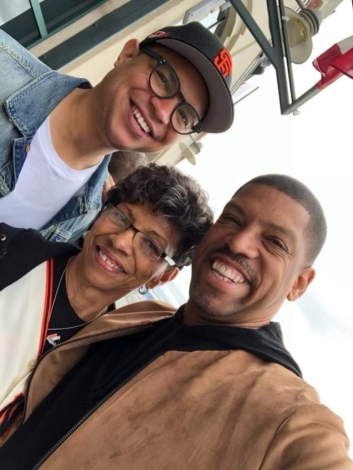 Former Sacramento Mayor Kevin Johnson, right, snaps a selfie with his brother, Ronnie West, and their mother, Georgia Rose Peat West, at Oracle Park, home of the San Francisco Giants.