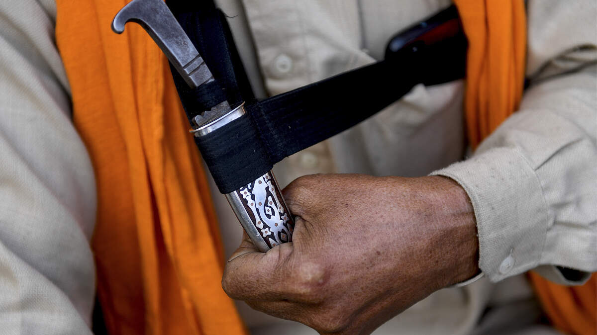 A Sikh farmer holds a kirpan – a blade carried by members of his faith as a part of a religious commandment – a few years ago in the northern Indian state of Punjab. A new Sacramento ordinance allows the items inside City Hall. 